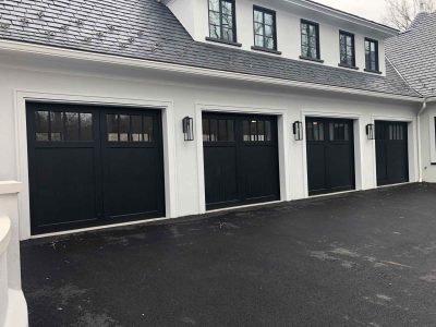 Black Garage Doors On White House
